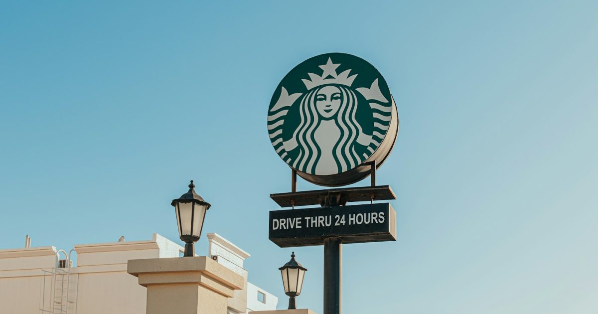 Photo by Kate Trysh A starbucks sign on top of a building